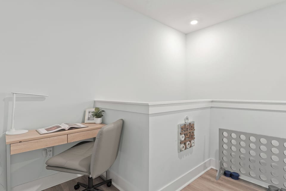 An upstairs landing adds a convenient workspace just outside the bedroom, perfect for catching up on emails or planning the day.