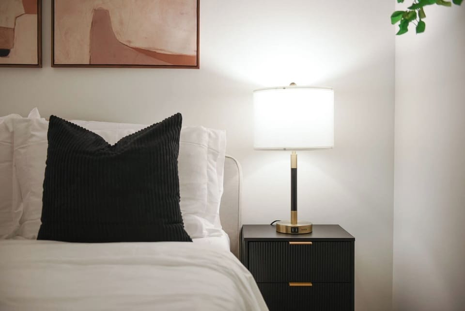 Stylish nightstand with lamp for a warm and relaxing ambiance.