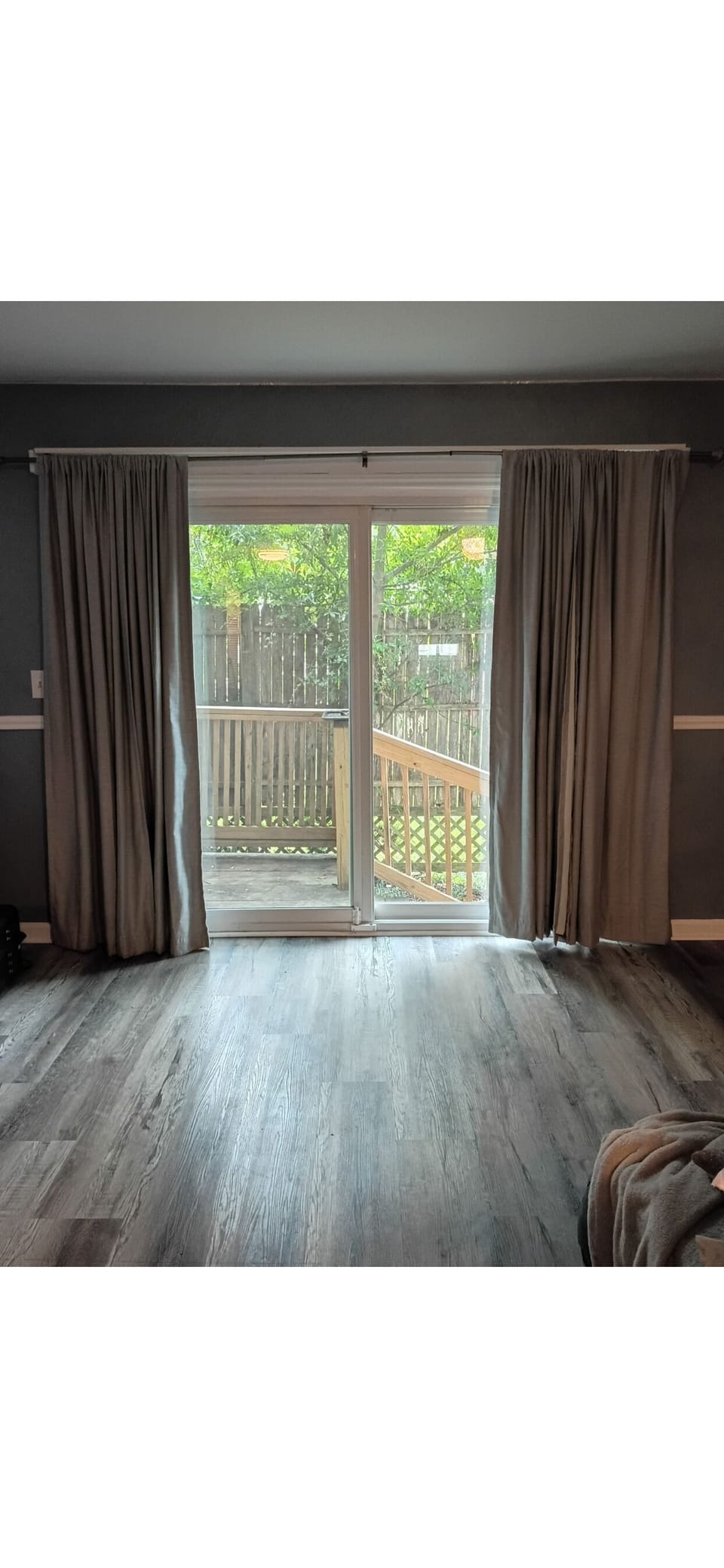sliding glass door in living room leading to back deck. 