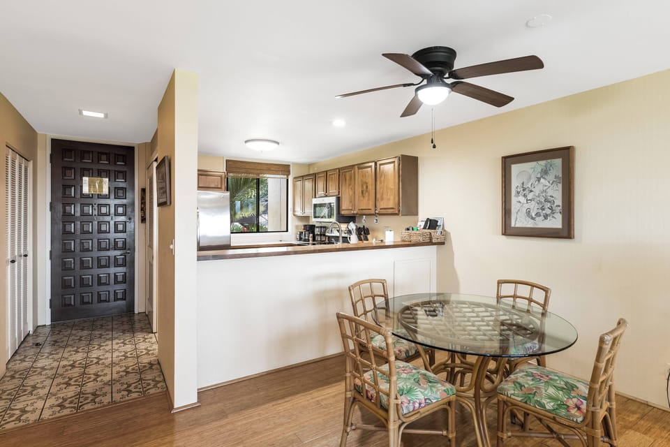 Gather around the glass dining table for meals with your group, while the open kitchen lets conversation flow effortlessly. The ceiling fan keeps things cool and comfortable.