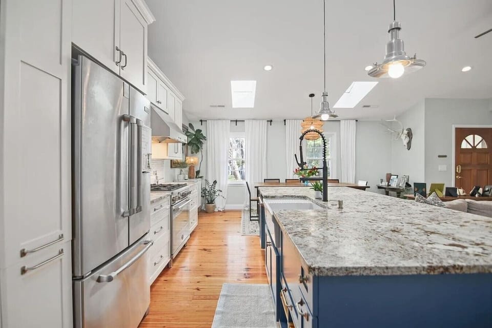 Bright and airy with skylights overhead, this kitchen flows right into the living space so no one`s stuck cooking alone when they`d rather be catching up with everyone.