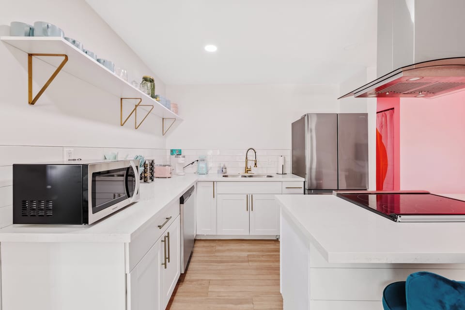 Bright modern kitchen with island cooktop and sleek stainless appliances