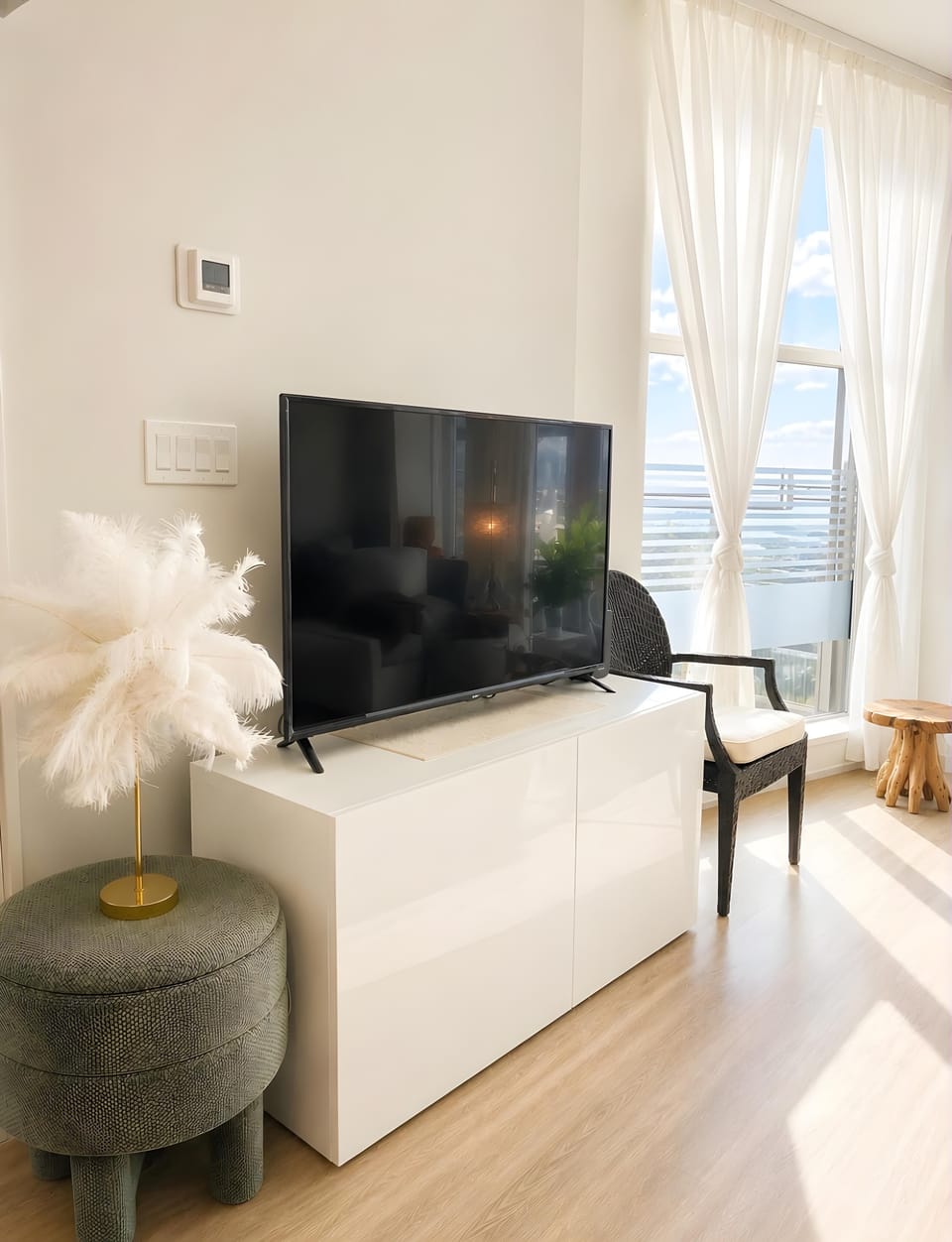 Cozy living area corner setup equipped with a 43" Smart TV with free major streaming platforms and minimalist entertainment console.