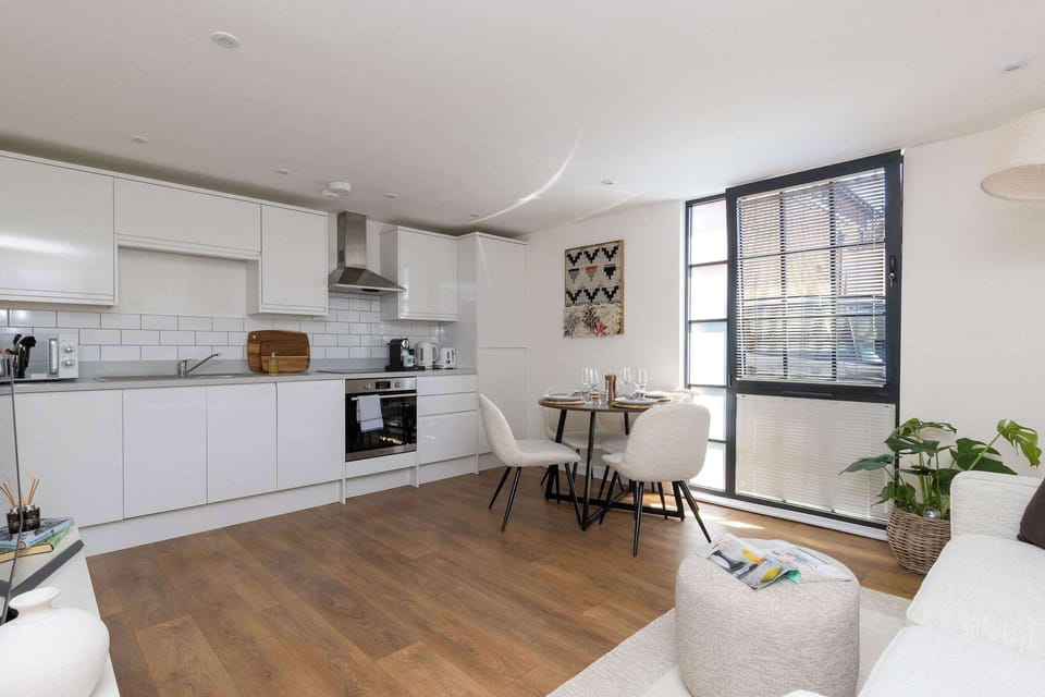 Bright open-plan living space with modern kitchen, perfect for stylish self-catering city breaks.