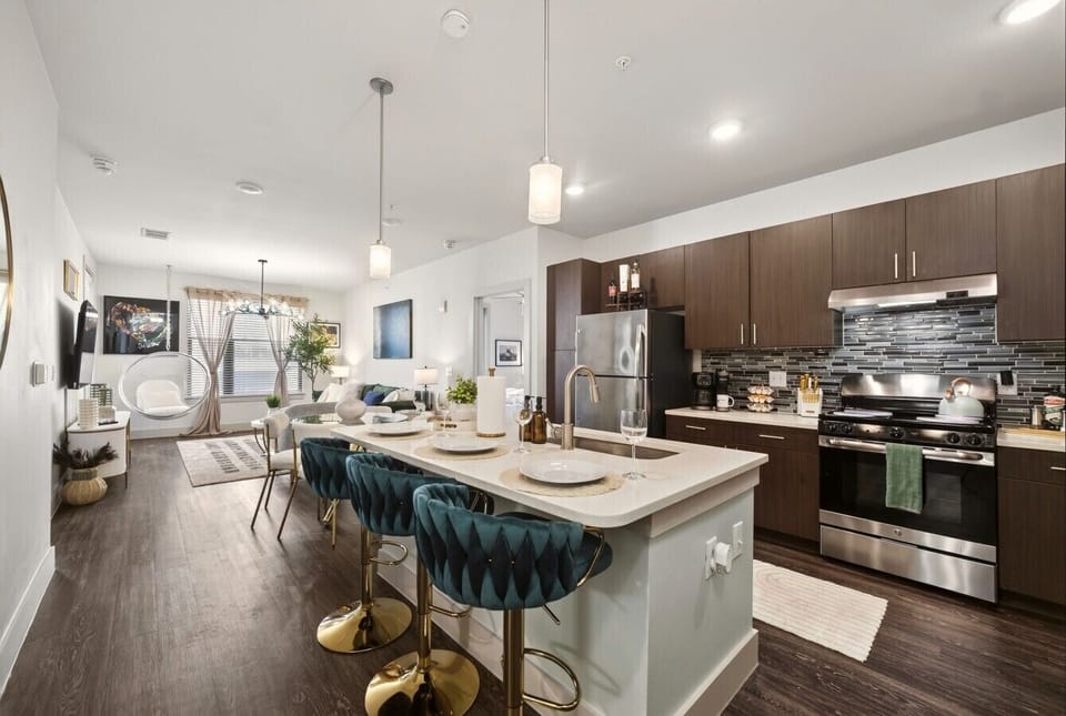 Chic Open Kitchen: Entertain with style in a bright space featuring modern decor and stainless steel appliances!