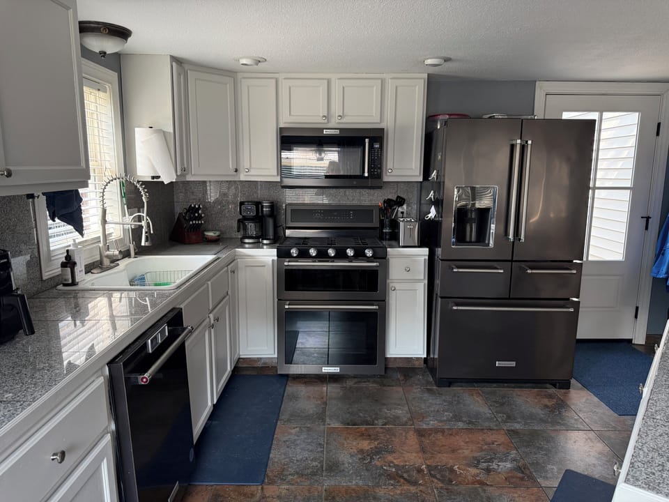 Bright modern kitchen with granite counters and stainless appliances