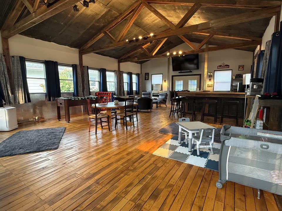 Spacious loft-style game room with bar, foosball, and family-friendly seating