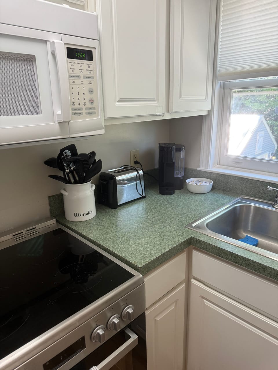 Bright, well-equipped kitchen with coffee maker and cooking essentials