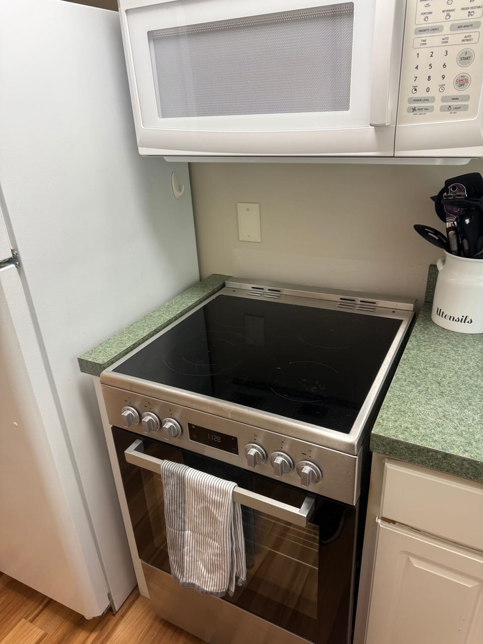 Modern kitchen setup with stainless range, microwave, and ready-to-use tools