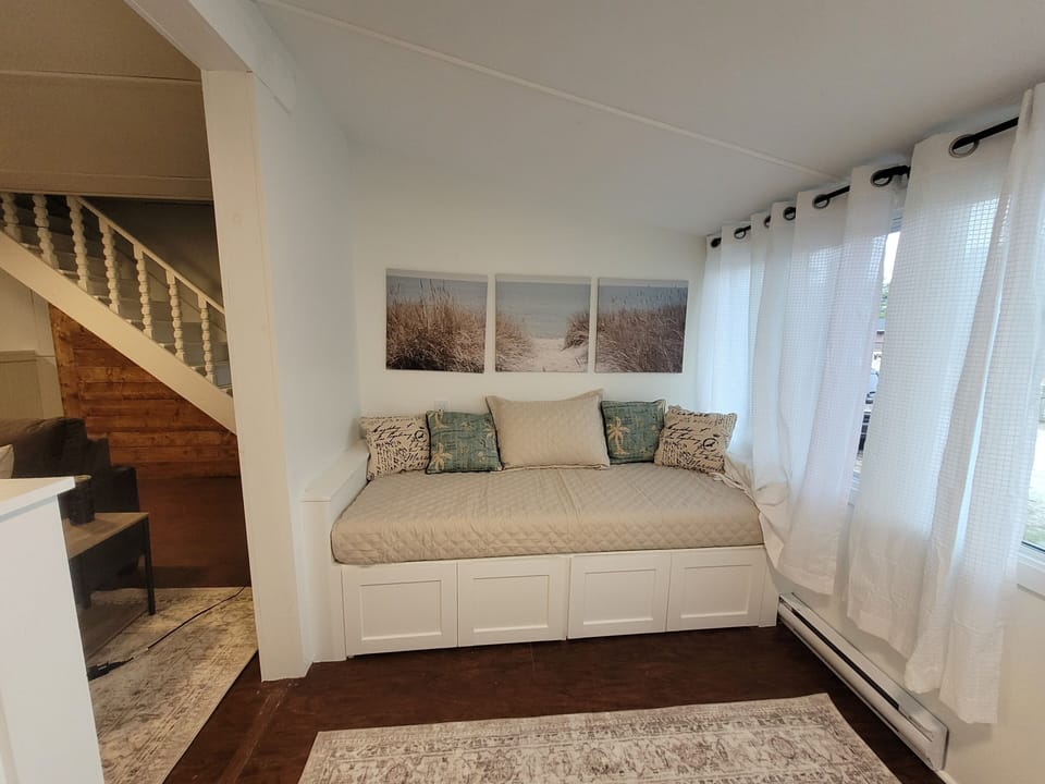 Sunroom daybed. Cozy up and read, scroll or take a nap.