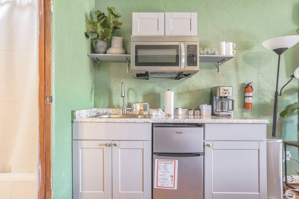 A kitchenette keeps you going: mini fridge, coffee maker, microwave, and basic dishes