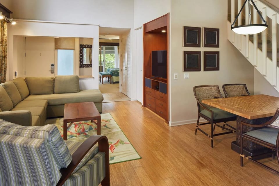Bright open living space with comfy seating, dining area, and built-in TV