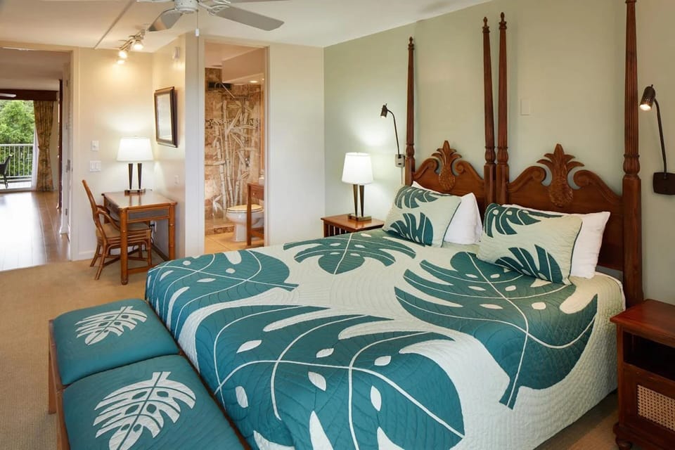 Spacious tropical-style bedroom with four-poster bed and balcony access