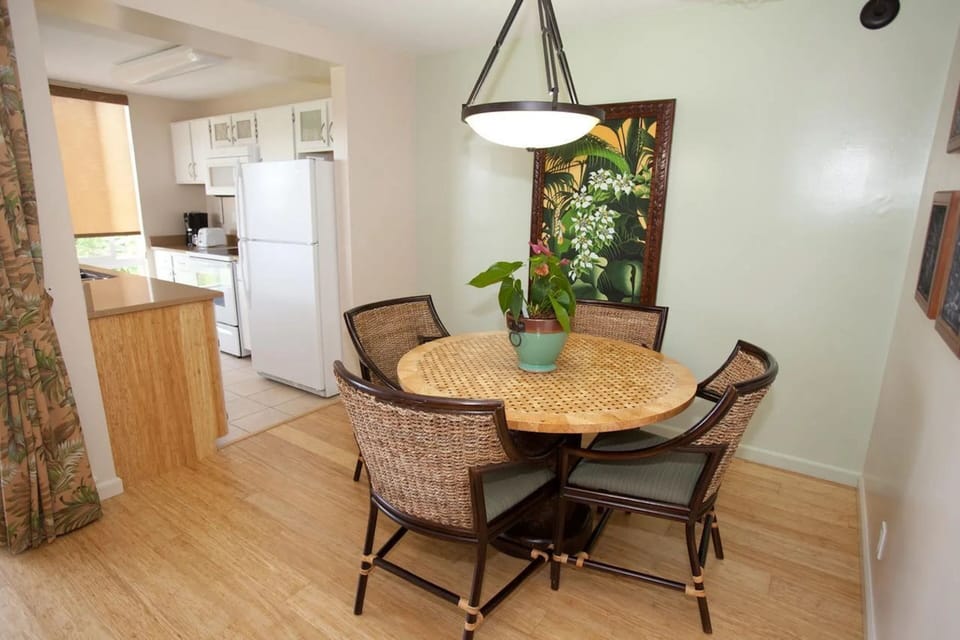 Bright tropical dining nook beside a fully equipped kitchen