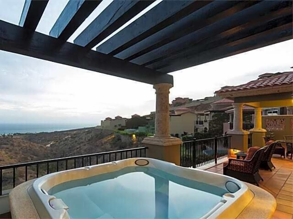 Private hot tub terrace with sweeping hillside and ocean views