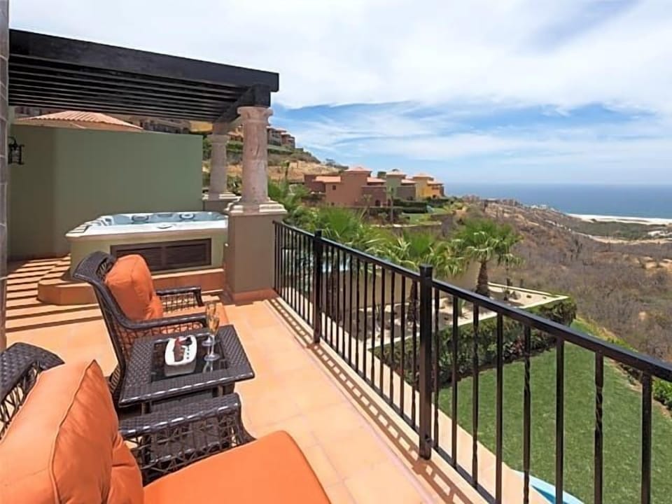 Private ocean-view terrace with hot tub and cozy outdoor seating