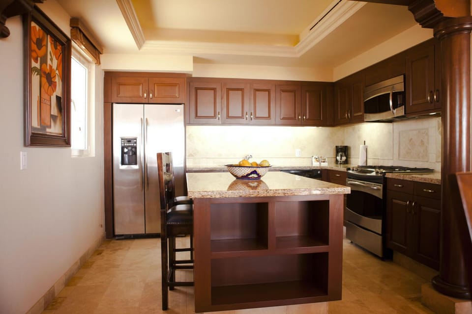 Elegant gourmet kitchen with granite island and stainless appliances