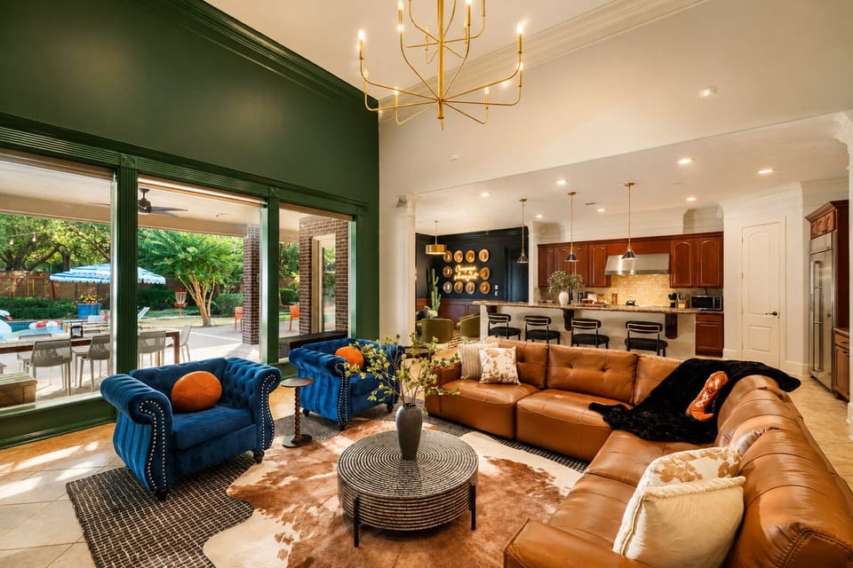 Bright open living space with patio access, luxe seating, and chef’s kitchen