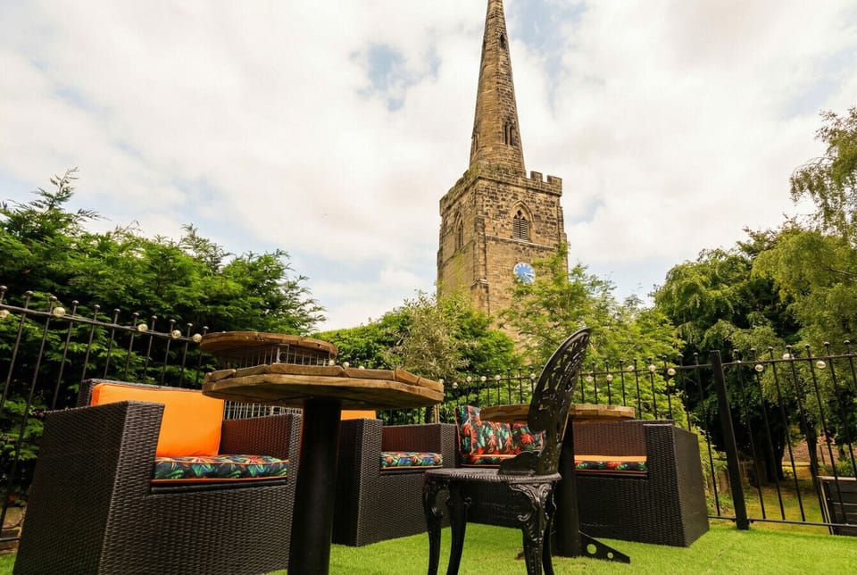Cocktails in the sun with a medieval church spire overhead, genuinely unlike anywhere else.