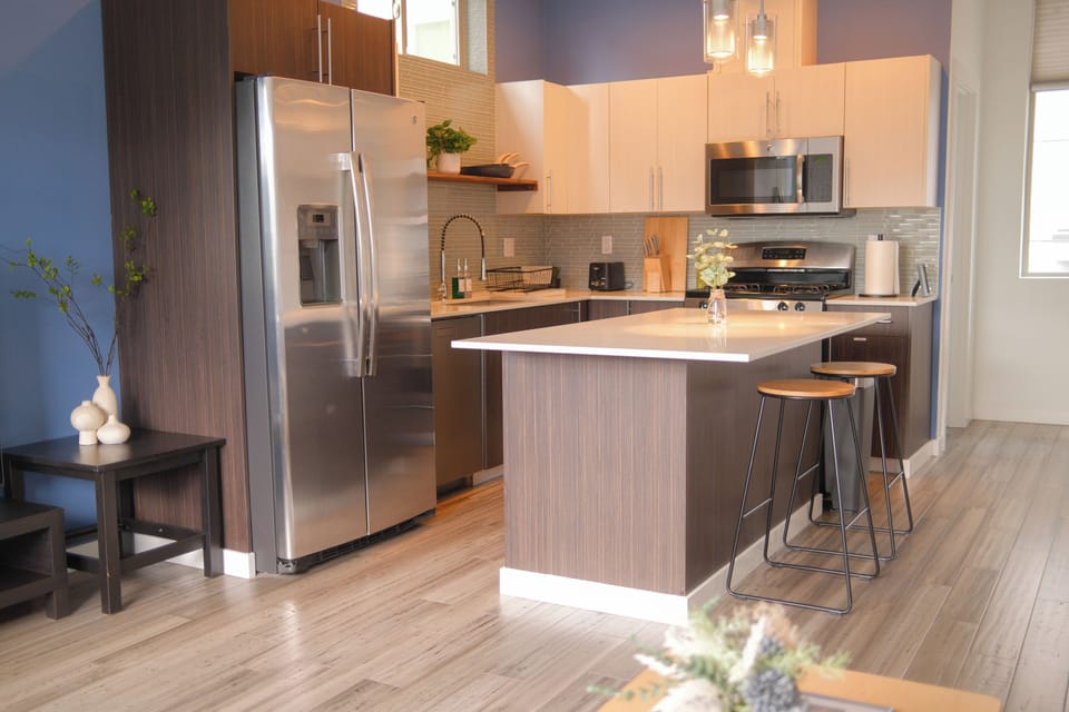 Modern kitchen with island seating and sleek stainless steel appliances
