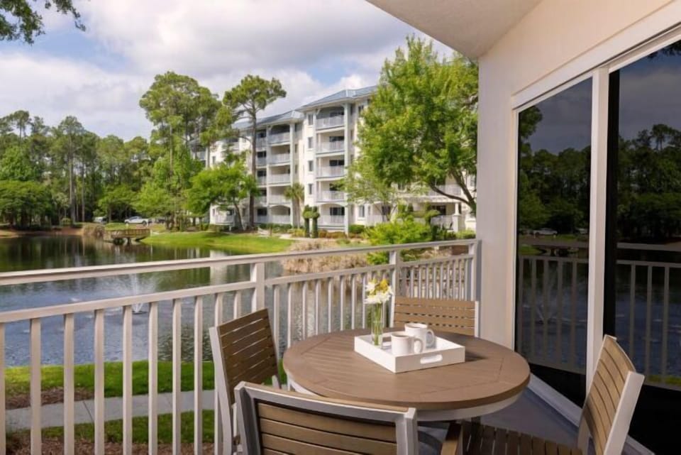 Private balcony with pond views and peaceful outdoor dining space