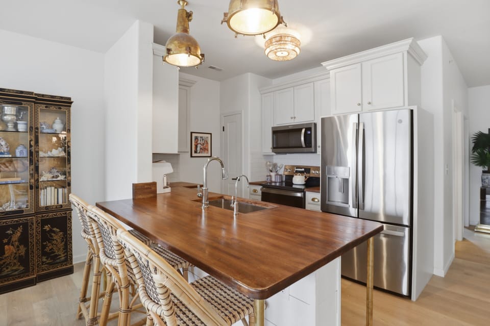 Designer kitchen with island seating and stainless steel appliances