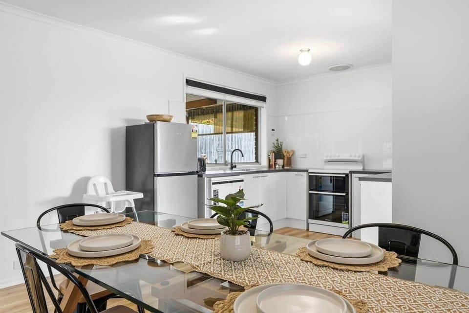 Gather around the spacious dining table for meals with family and friends.