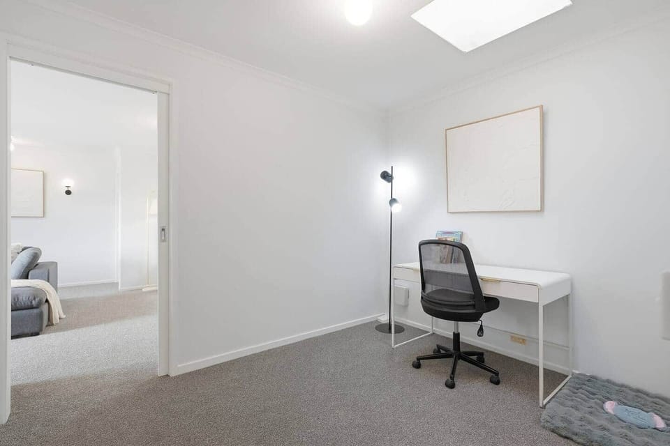 Bright and spacious living room with comfortable seating and stunning mountain views through the balcony doors.