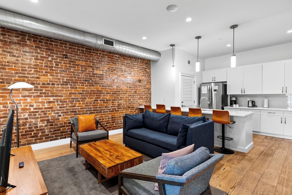 Open-plan layout showing the seamlessly connected living room and modern kitchen.