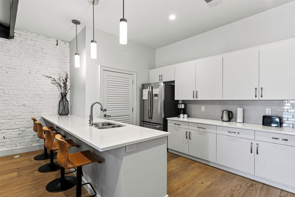 The modern layout keeps everyone in on the conversation, seamlessly connecting the kitchen to the living room.