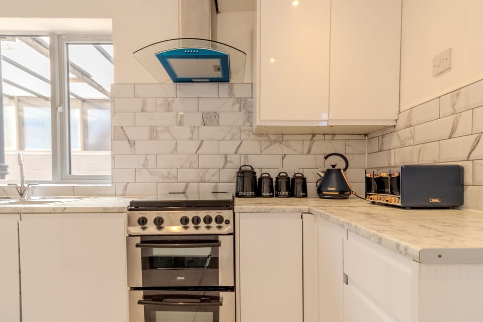 Bright modern kitchen with marble finishes and full cooking space