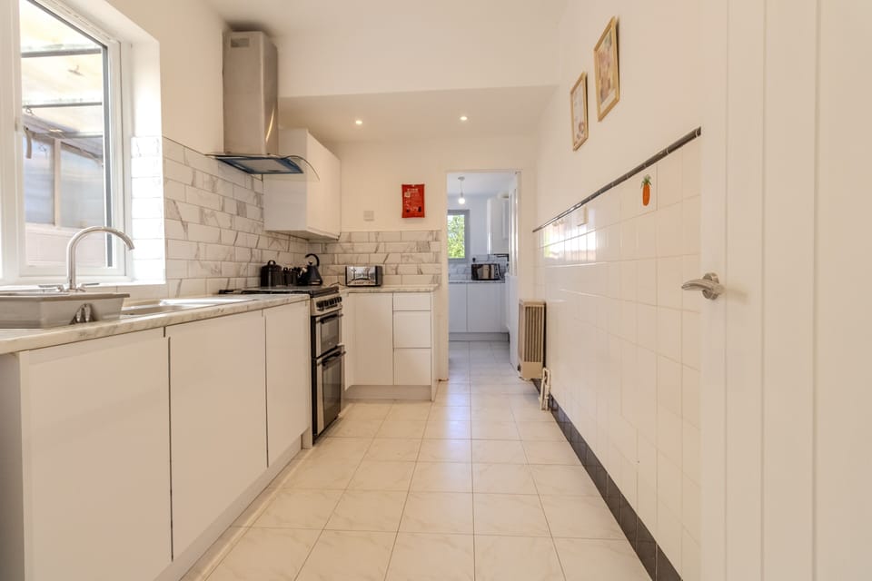 Bright galley kitchen with modern finishes and plenty of natural light