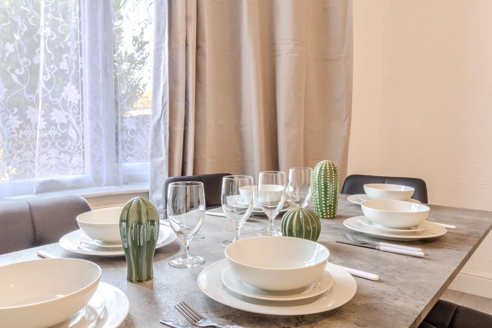 Bright, stylish dining space set for a cozy shared meal