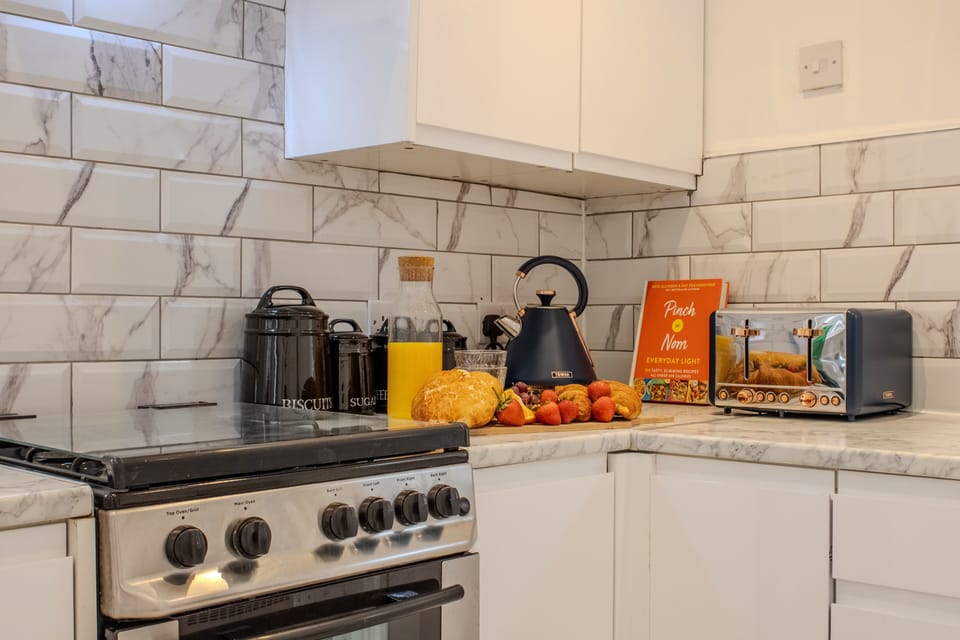 Bright modern kitchen with stylish finishes and a welcoming breakfast setup