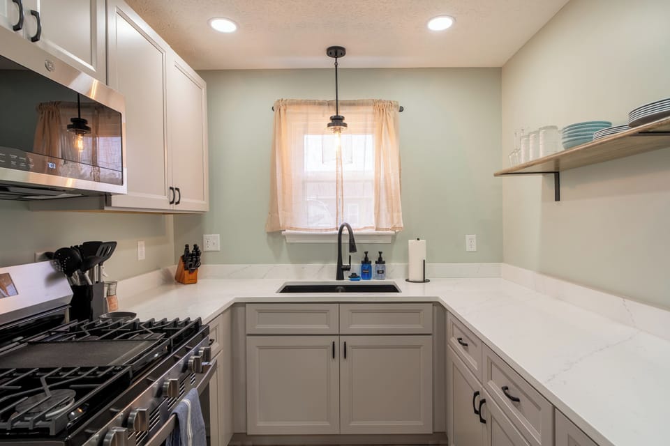 Brand new kitchen cabinets and counter top with plenty of dishes, pots and pans for your stay
