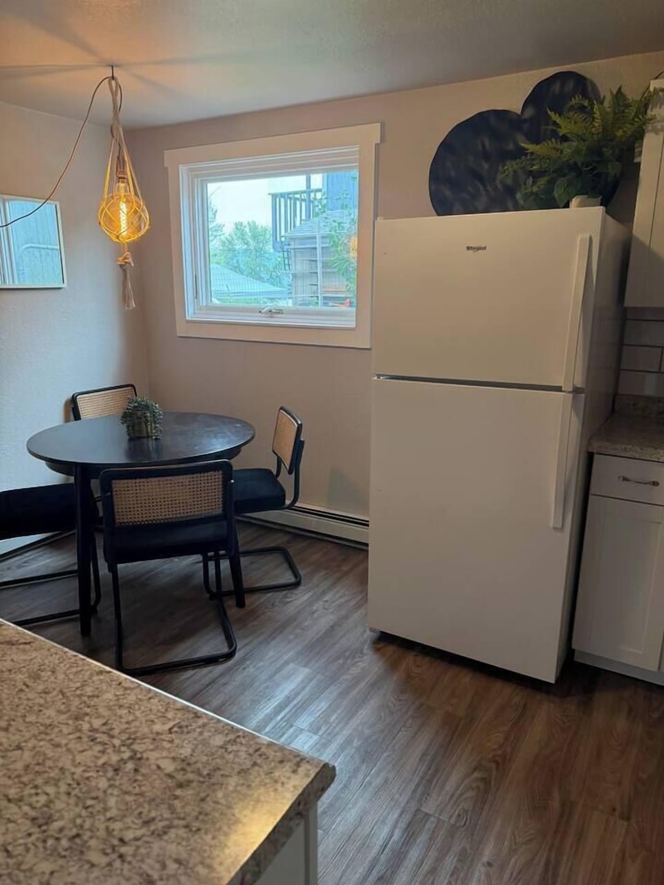 Enjoy meals in the bright dining nook, conveniently located beside the fully equipped kitchen and filled with natural light.