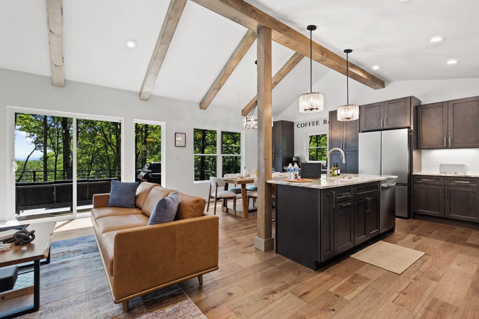 Tall beamed ceilings + big windows fill the main living space with natural light