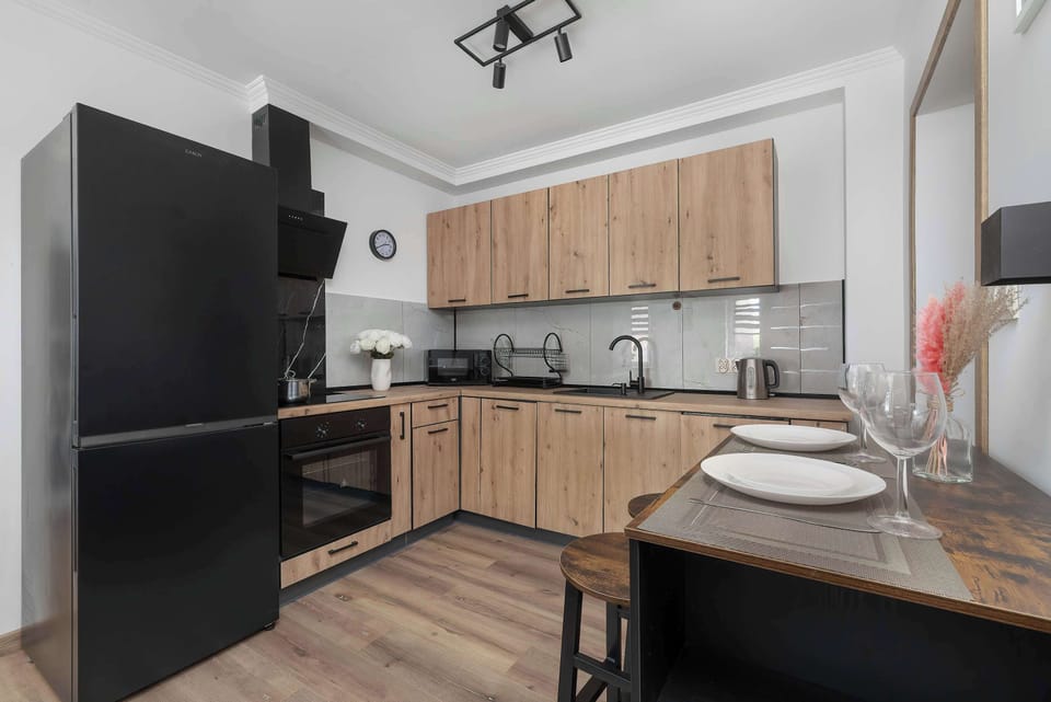 The sleek design of the kitchenette blending seamlessly with the living area.