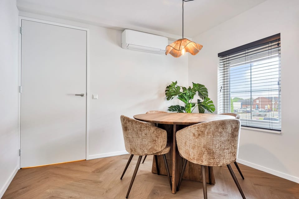 Spacious dining area with air conditioning, offering a comfortable place to enjoy breakfast, lunch, or dinner together.