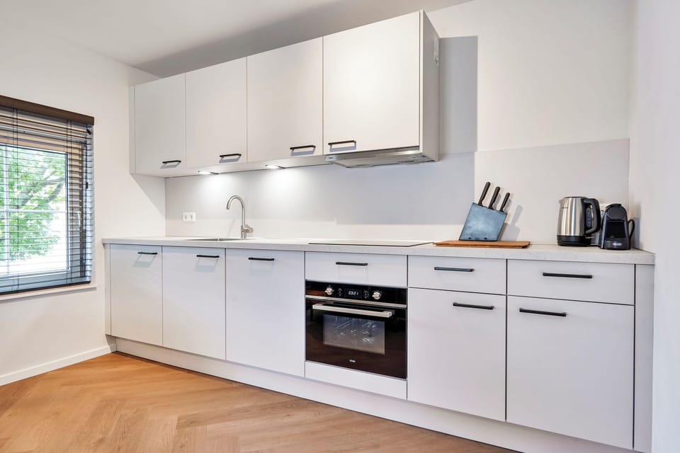Prepare your favorite meals in the fully equipped private kitchen with an oven, cooktop, refrigerator, and everything you need for longer stays.