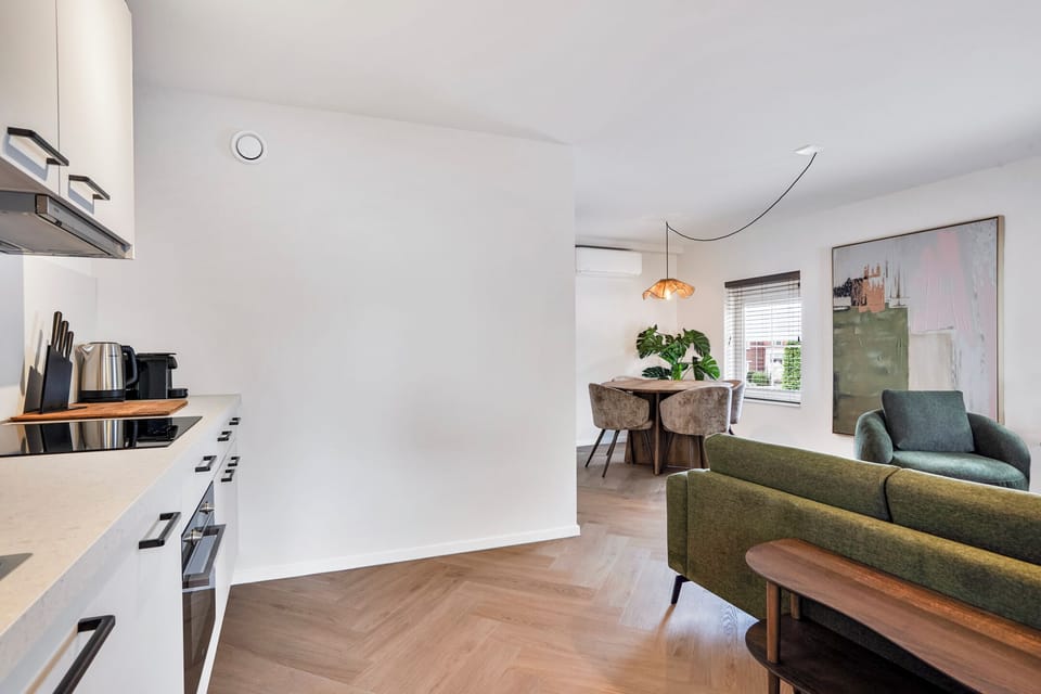 Open-concept apartment with a fully equipped private kitchen, dining area, air conditioning, and comfortable living space for up to 3 guests.