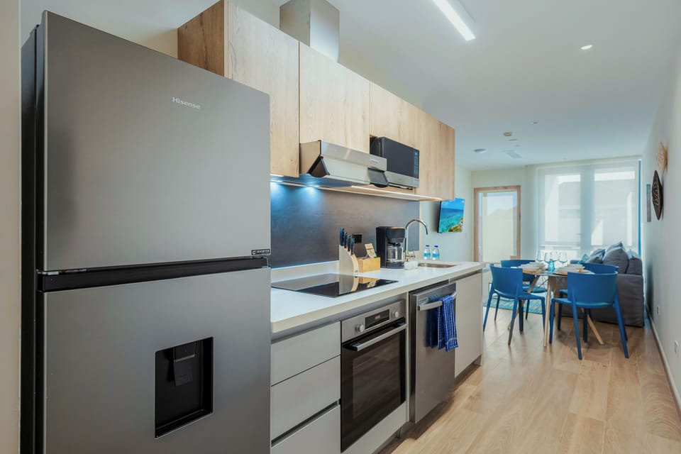 Step into your bright, open-plan kitchen with modern appliances and sleek countertops, perfect for preparing meals and gathering around the dining table with your favorite people.
