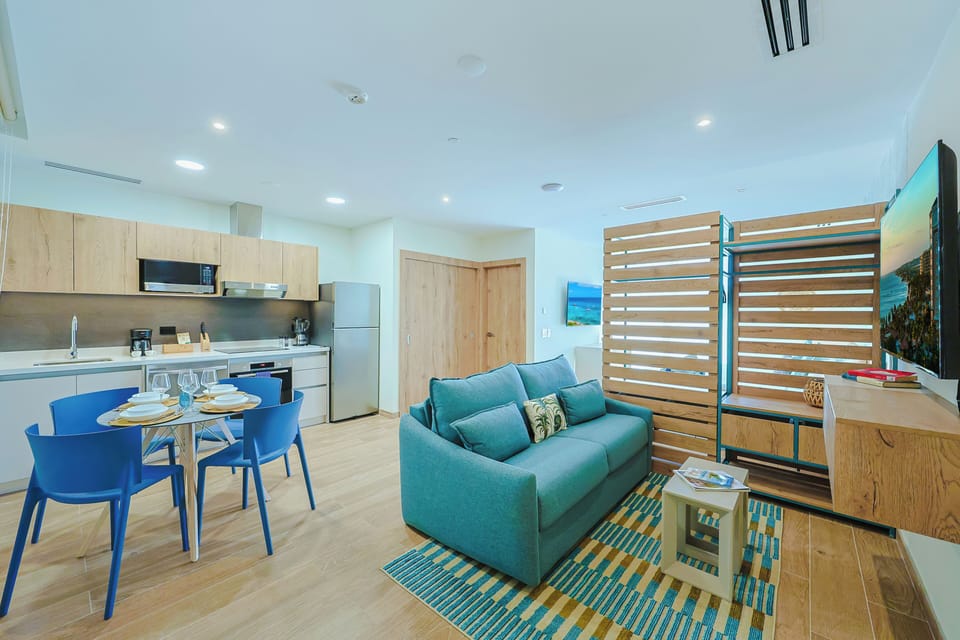 Your bright coastal-inspired retreat combines a modern kitchen, cozy living area, and thoughtful bunk space—perfect for relaxing, dining, or gathering after a day of adventure.