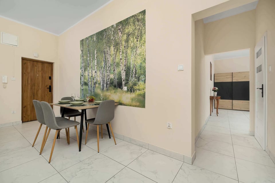 A dining area next to the kitchen with seating for four guests. The bright interior creates a comfortable space for meals.