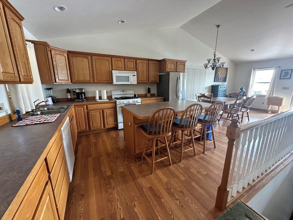 Large kitchen with dishwasher, gas stove, oven, microwave, coffee maker, blender