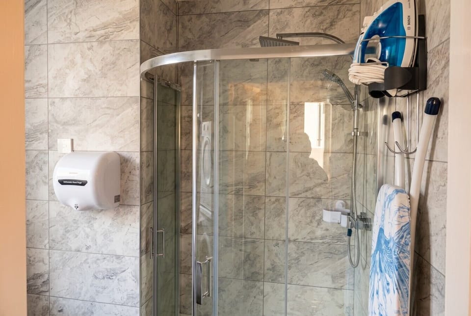 Ensuite shower stocked with iron and fresh towels