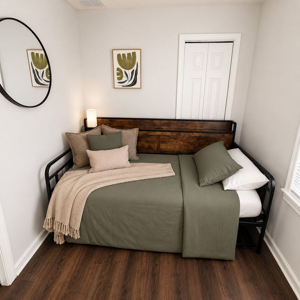 Cozy daybed nook with soft linens, warm wood accents, and modern decor