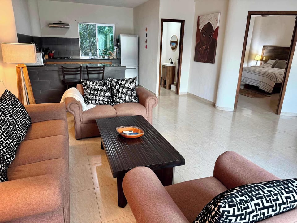Living room, with view into kitchen and bedroom.