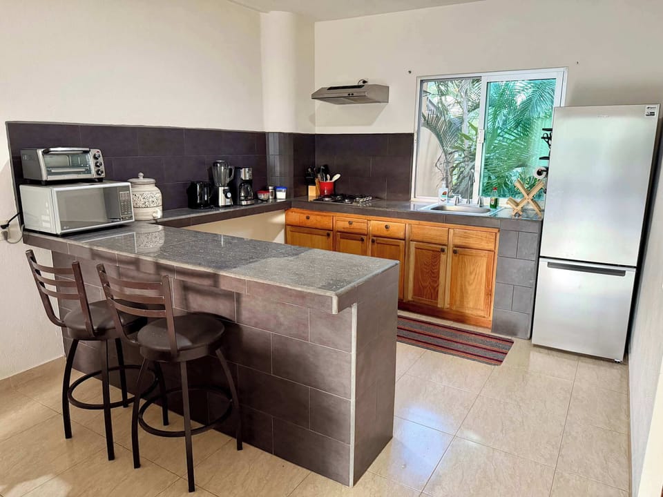 Full kitchen with bar seating.
