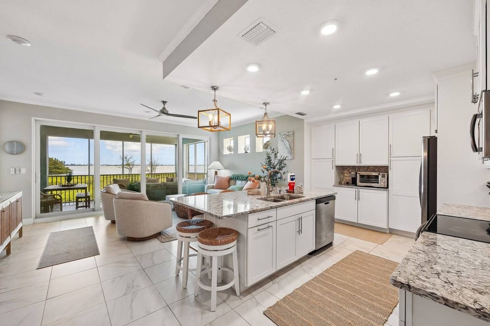 Open-concept kitchen and living area overlooking the bay takes cooking to another level